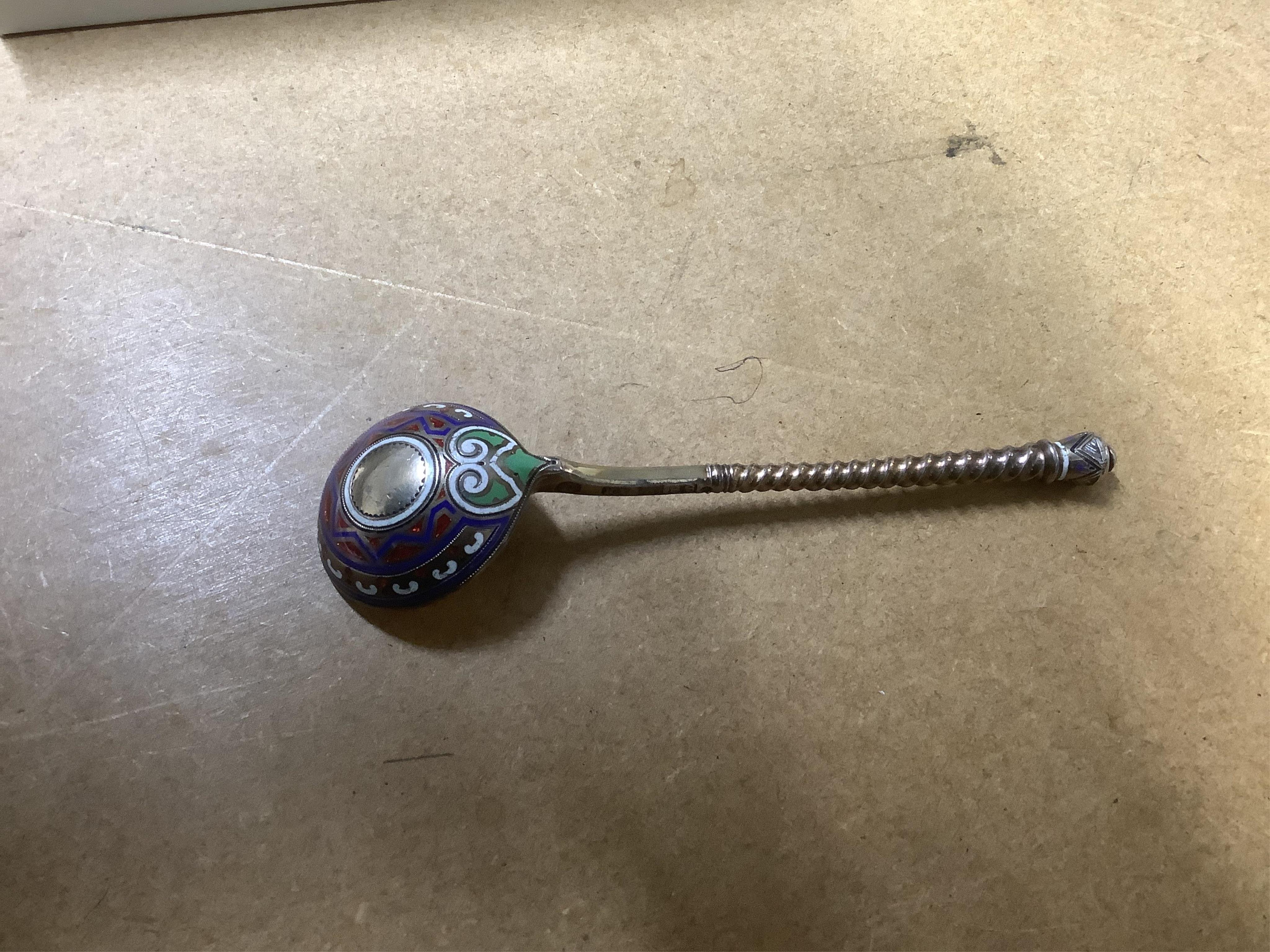 A George VI Arts & Crafts silver seal top spoon by Amy Sandheim, London, 1948, 14.2cm, a 19th century Russian 88 zolotnik and enamel spoon, assay master B.C, 1874, a 19th century silver caddy spoon and three silver ladle